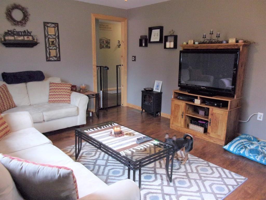 158 Osborne Road Ware, MA 01082 - Photo 19 of 31 a living room with furniture a flat screen tv and kitchen view