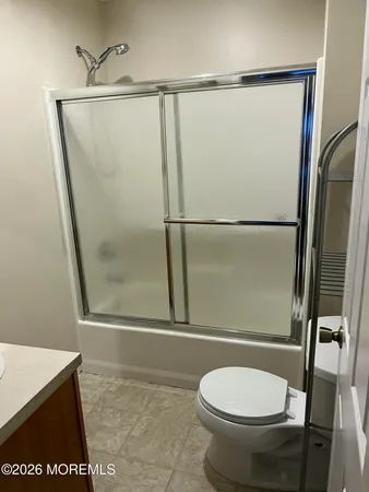 a bathroom with a toilet and a shower