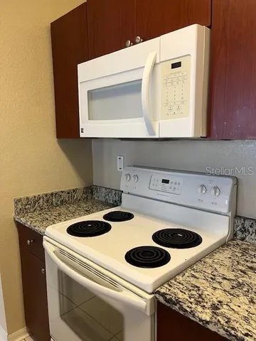a kitchen with a stove and a microwave