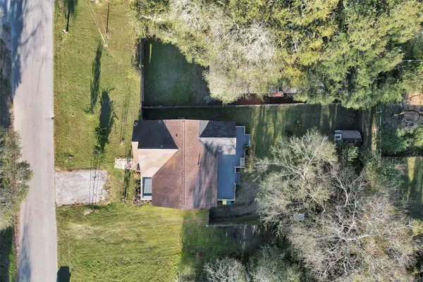 an aerial view of a house with a yard