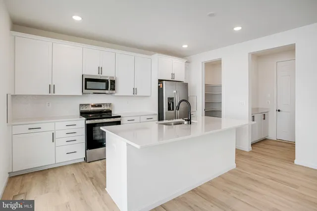 a kitchen with stainless steel appliances granite countertop a sink and a stove