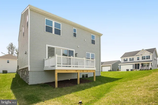 a front view of a house with swimming pool and porch