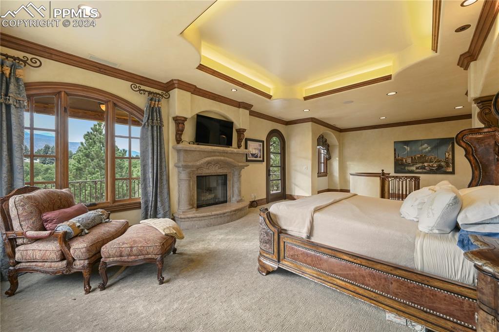 22 Crossland Road Colorado Springs, CO 80906 - Photo 17 of 49 a spacious bedroom with a bed and a fireplace