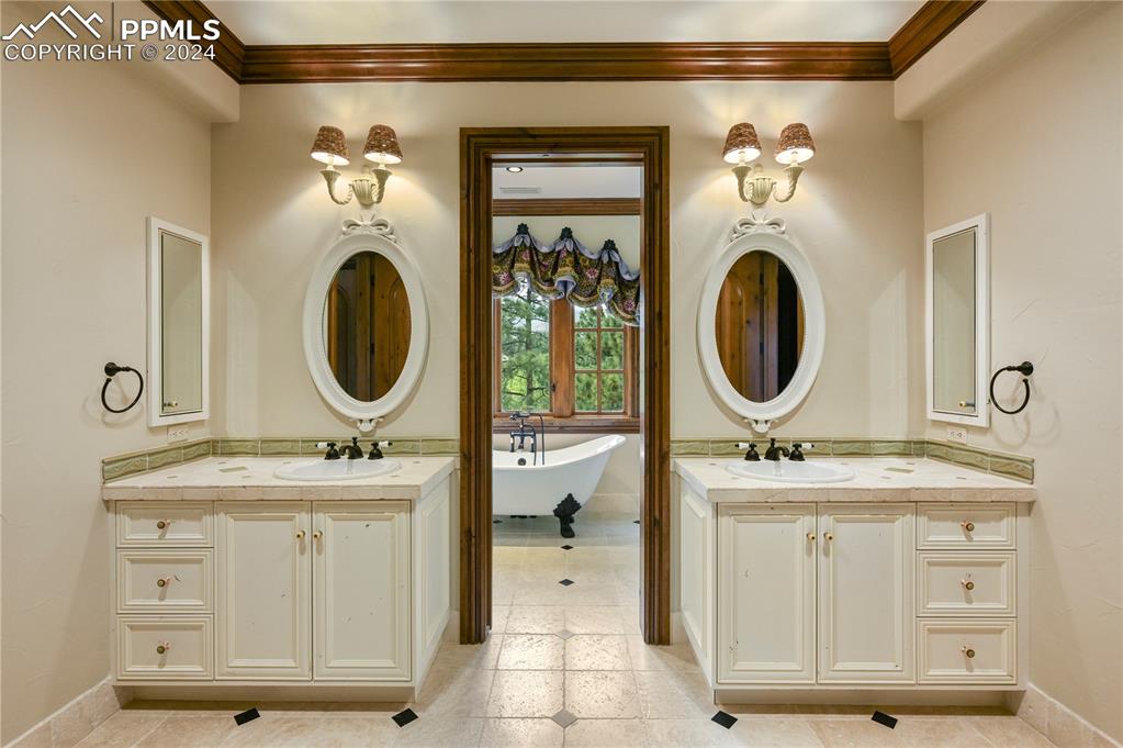 22 Crossland Road Colorado Springs, CO 80906 - Photo 27 of 49 a bathroom with a toilet a sink and a mirror
