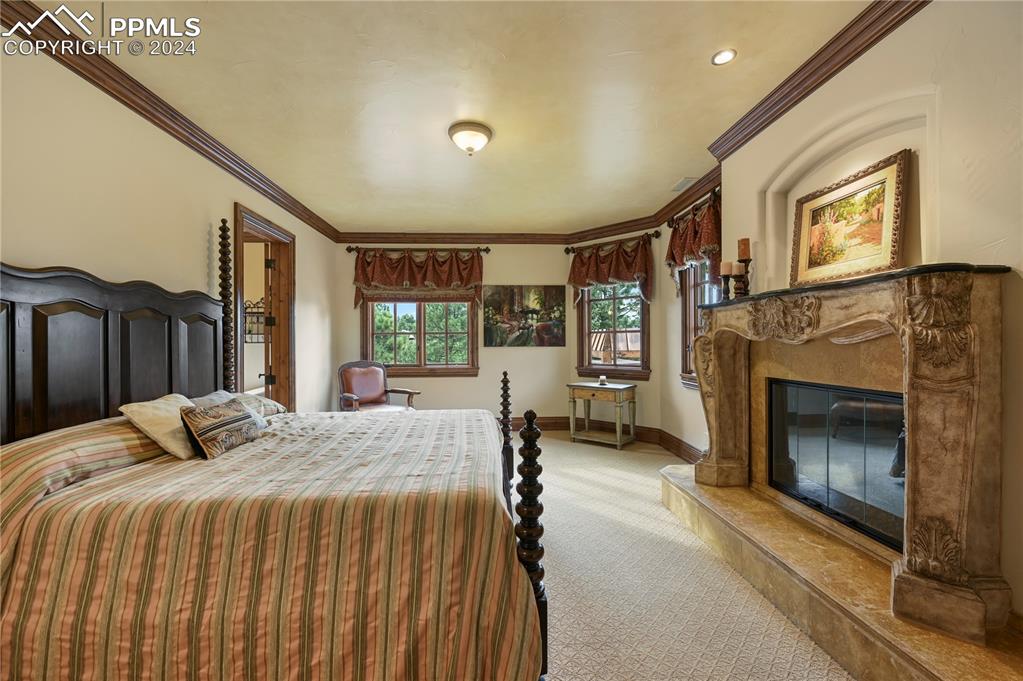 22 Crossland Road Colorado Springs, CO 80906 - Photo 28 of 49 a bedroom with a bed and a fireplace