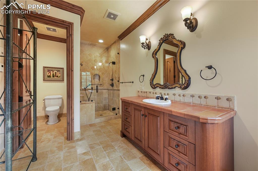 22 Crossland Road Colorado Springs, CO 80906 - Photo 29 of 49 a bathroom with a double vanity sink mirror and toilet