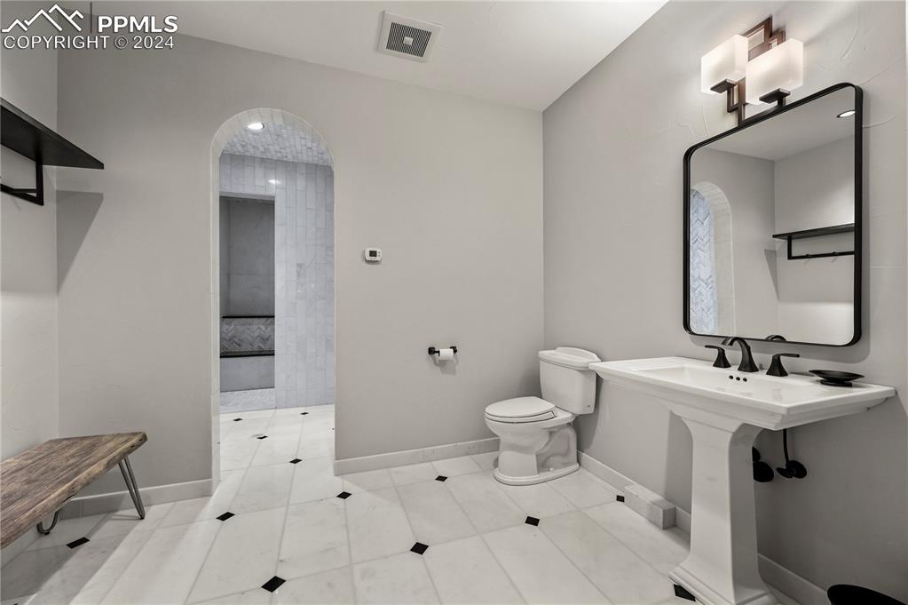 22 Crossland Road Colorado Springs, CO 80906 - Photo 36 of 49 a bathroom with a toilet sink and mirror