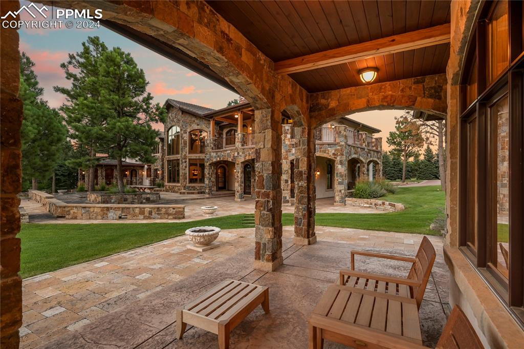 22 Crossland Road Colorado Springs, CO 80906 - Photo 41 of 49 a view of a patio with a table chairs and a yard