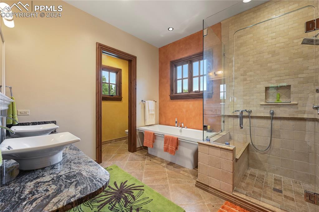 22 Crossland Road Colorado Springs, CO 80906 - Photo 45 of 49 a bathroom with a granite countertop toilet a sink and a bathtub