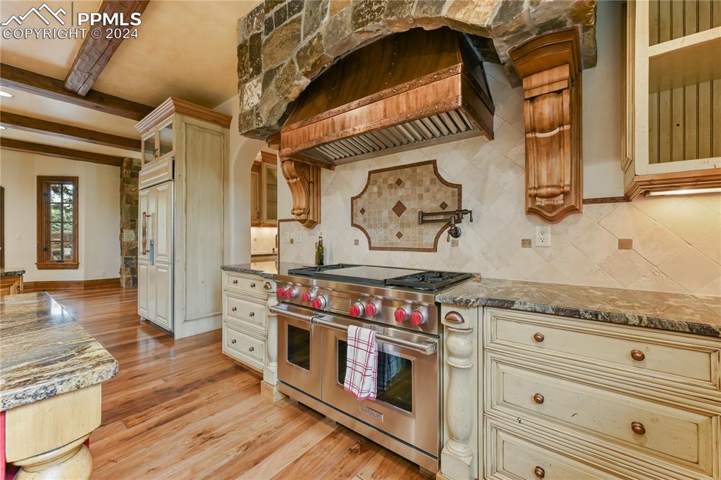 22 Crossland Road Colorado Springs, CO 80906 - Photo 9 of 49 a kitchen with stainless steel appliances granite countertop a stove and a wooden floor