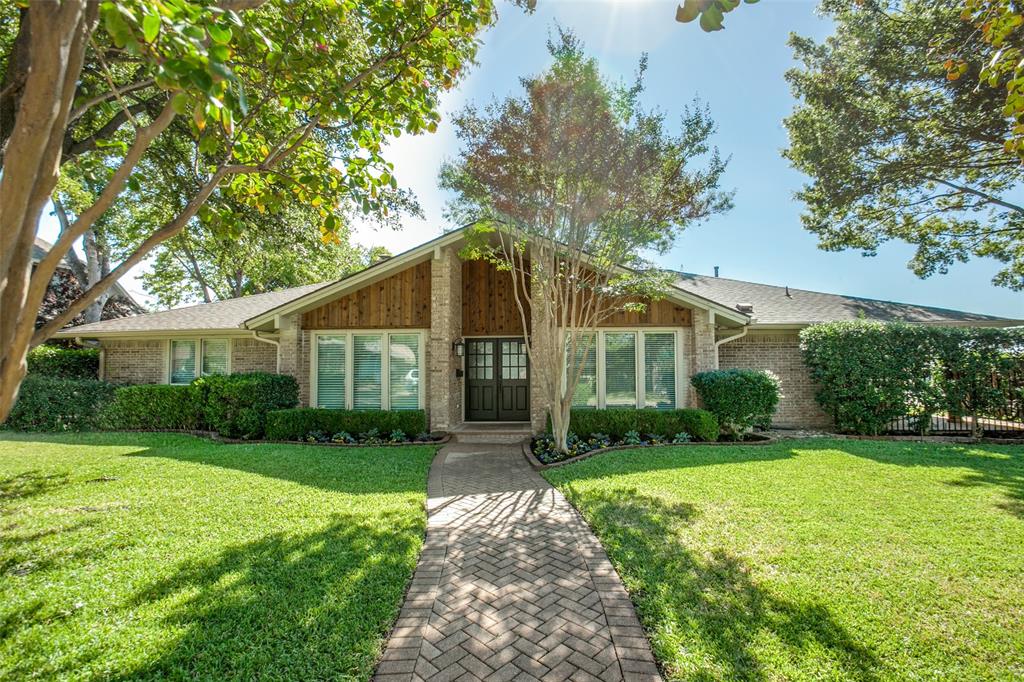 View of front of home featuring a front lawn and brick siding