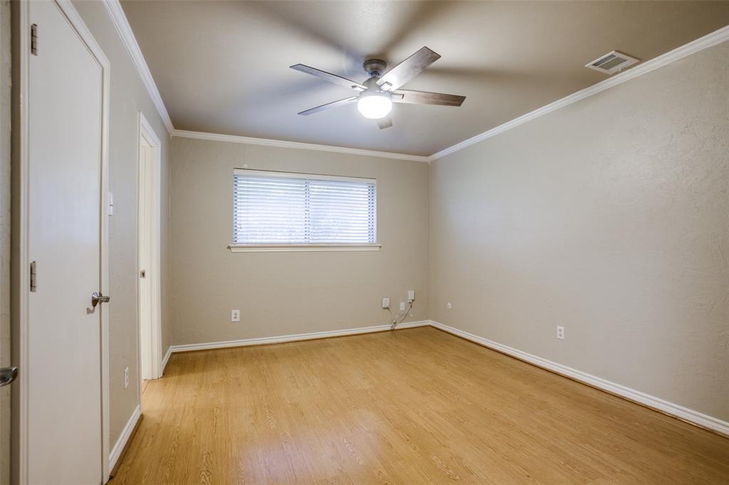 2700 Quail Ridge Drive Carrollton, TX 75006 - Photo 12 of 30 Unfurnished bedroom featuring crown molding, ceiling fan, and light wood-style flooring