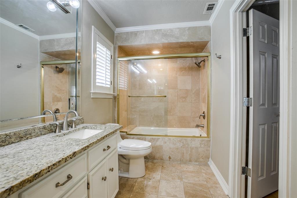 2700 Quail Ridge Drive Carrollton, TX 75006 - Photo 17 of 30 Bathroom featuring vanity, ornamental molding, and tiled shower / bath combo