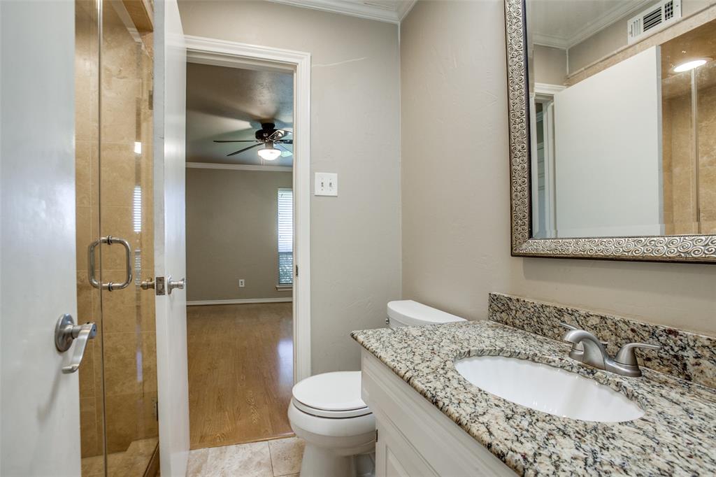2700 Quail Ridge Drive Carrollton, TX 75006 - Photo 19 of 30 Full bath with crown molding, a shower stall, and vanity