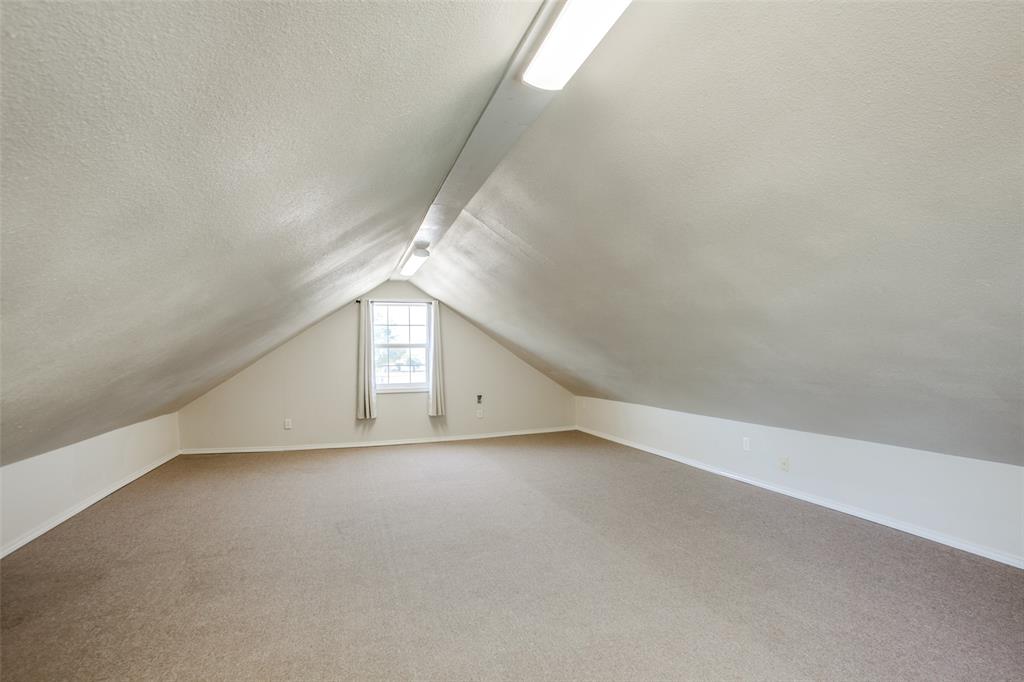 2700 Quail Ridge Drive Carrollton, TX 75006 - Photo 20 of 30 Bonus room featuring vaulted ceiling, light colored carpet, and a textured ceiling