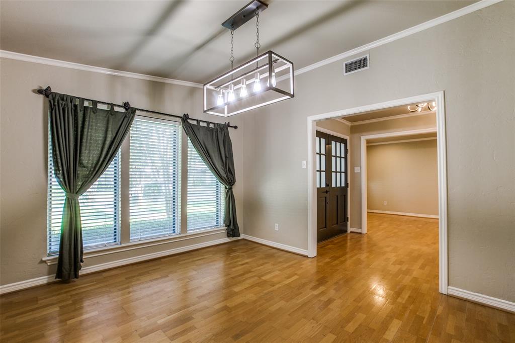 2700 Quail Ridge Drive Carrollton, TX 75006 - Photo 3 of 30 Unfurnished dining area featuring crown molding and light wood finished floors