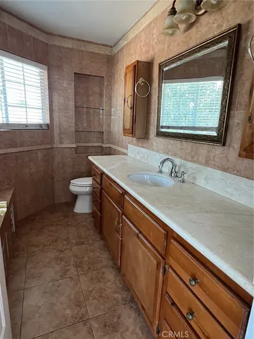 a bathroom with a granite countertop sink a mirror bathtub and shower