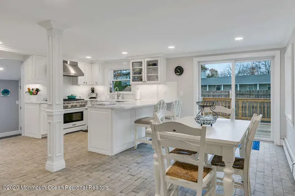 a kitchen with cabinets and chairs