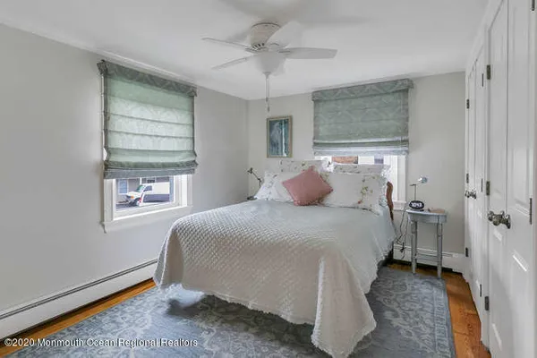 a bedroom with two beds and a dresser