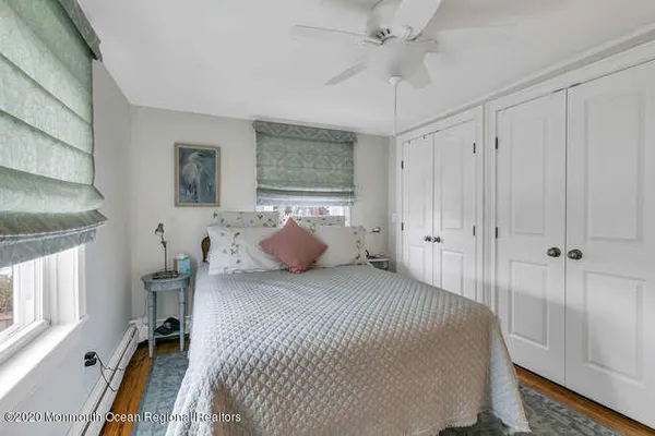 a living room with a bed furniture and a window