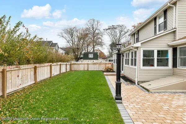 a view of a house with a yard and sitting area