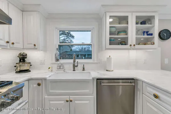 a kitchen with stainless steel appliances granite countertop a sink stove and cabinets
