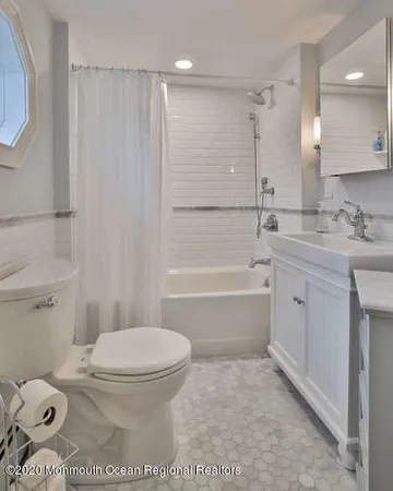 a bathroom with a toilet a sink and bathtub