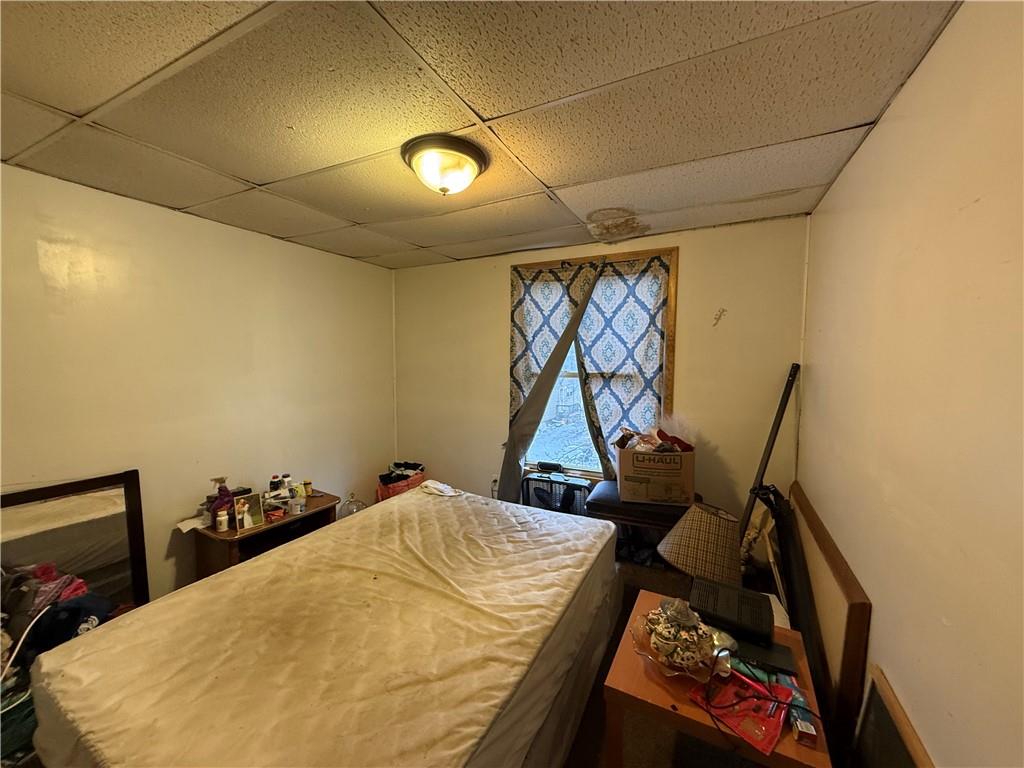 328 West Cunningham Street Butler, PA 16001 - Photo 12 of 15 a bed sitting in a bedroom next to a window