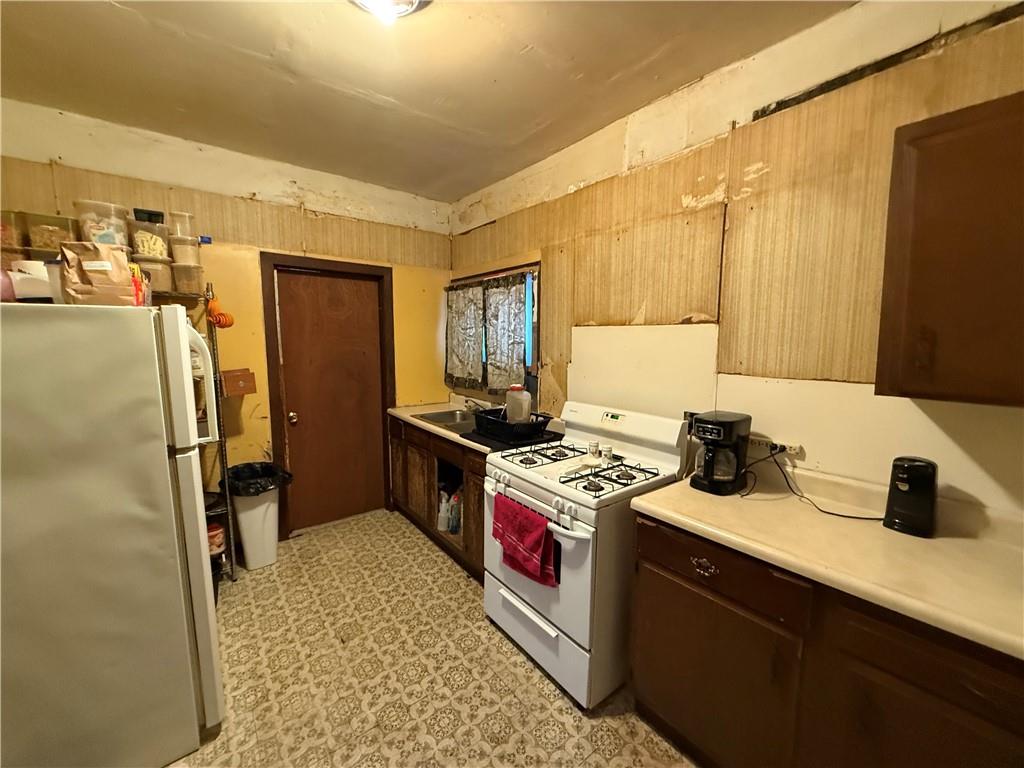 328 West Cunningham Street Butler, PA 16001 - Photo 16 of 16 a kitchen with a sink stove and refrigerator