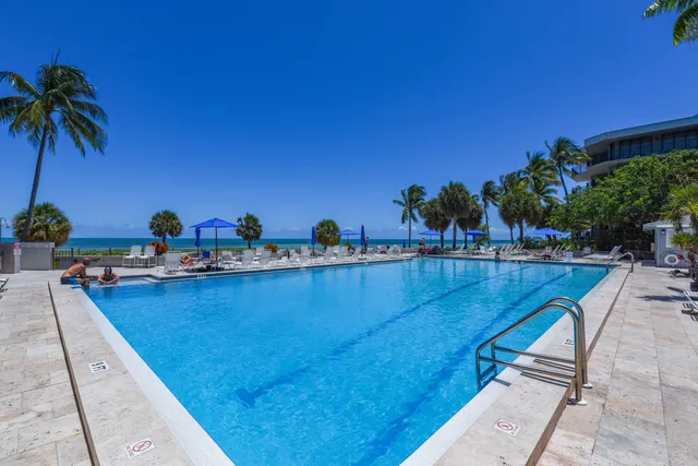 a outdoor space with the couches and dining table with the garden view