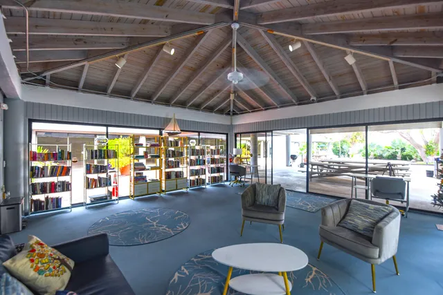 swimming pool with outdoor seating and trees