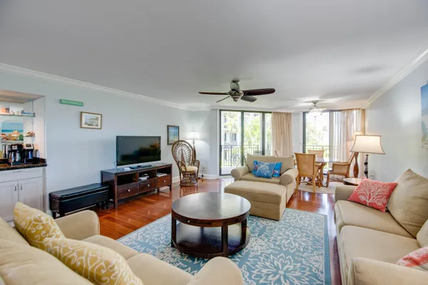 a living room with furniture a large window and a flat screen tv