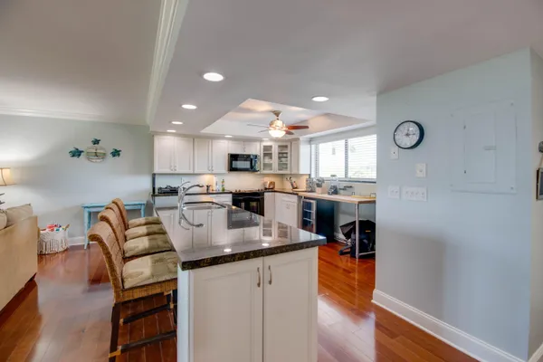 a kitchen with stainless steel appliances granite countertop a refrigerator and a stove top oven