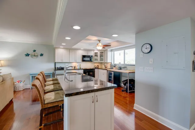 a kitchen with stainless steel appliances granite countertop a refrigerator and a stove top oven