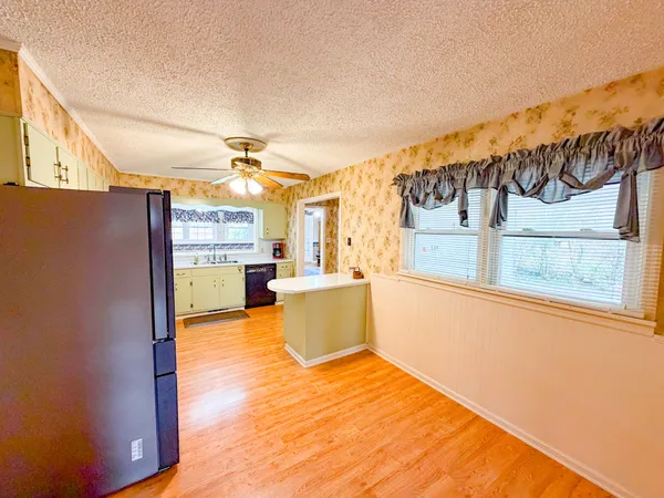 a kitchen with a sink and wooden cabinets