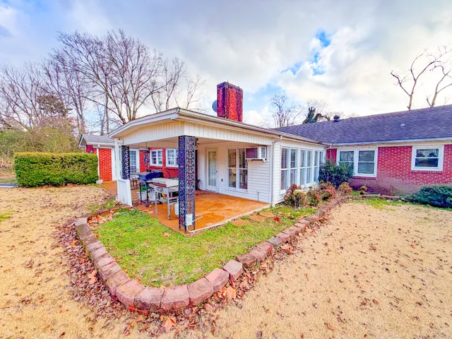 a view of a kitchen with kitchen island a stove a refrigerator cabinets a dining table and chairs with wooden floor