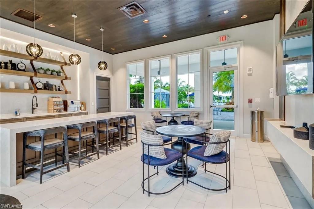 9175 Cayman Drive Naples, FL 34114 - Photo 21 of 31 a view of a dining room with furniture window and outside view