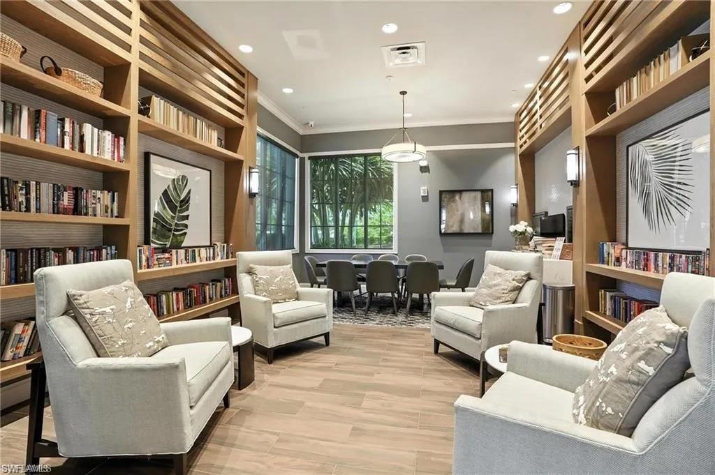 9175 Cayman Drive Naples, FL 34114 - Photo 22 of 31 a living room with furniture and a book shelf