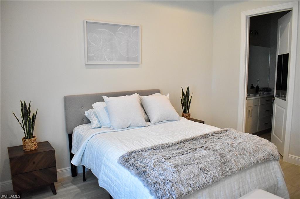 9175 Cayman Drive Naples, FL 34114 - Photo 7 of 31 a bedroom with a bed and a couch