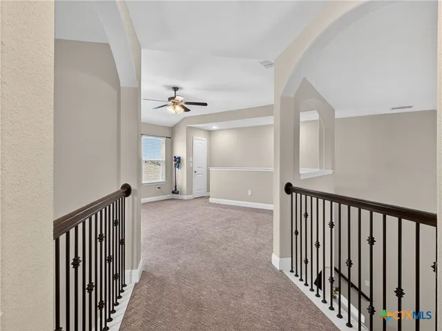 a view of a hallway with entryway door