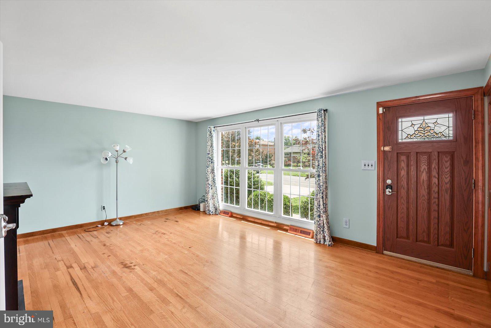 2453 Brookside Lane York, PA 17402 - Photo 13 of 40 an empty room with wooden floor and windows