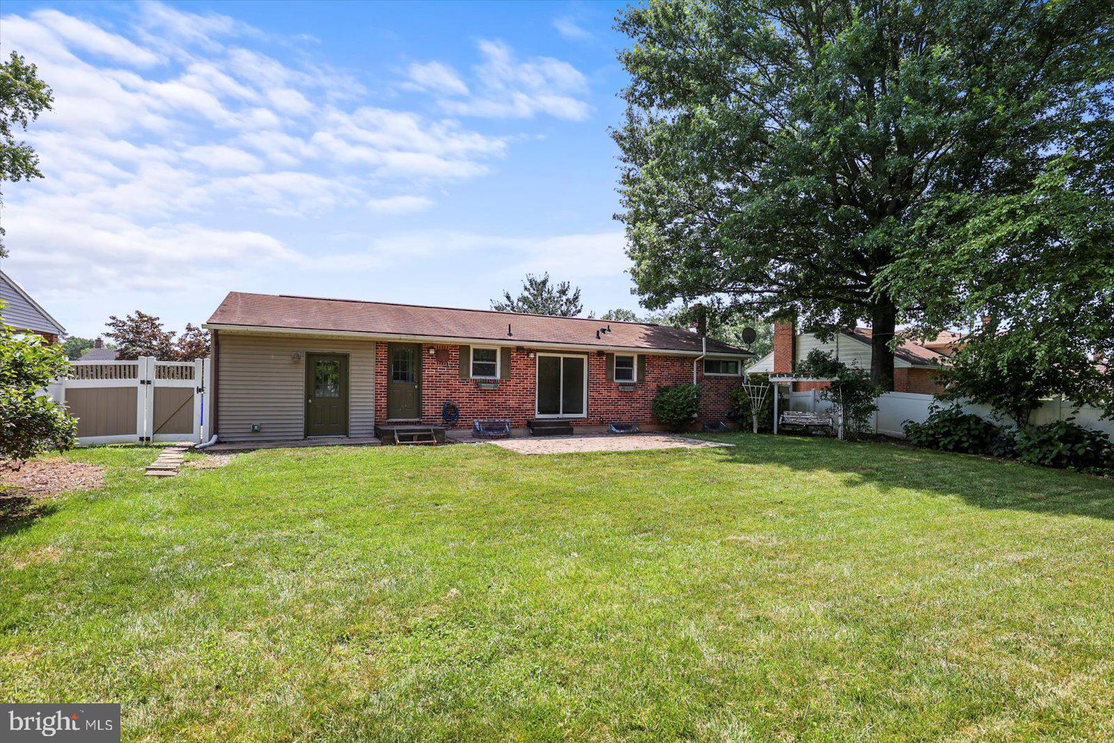 2453 Brookside Lane York, PA 17402 - Photo 5 of 40 a front view of a house with a garden