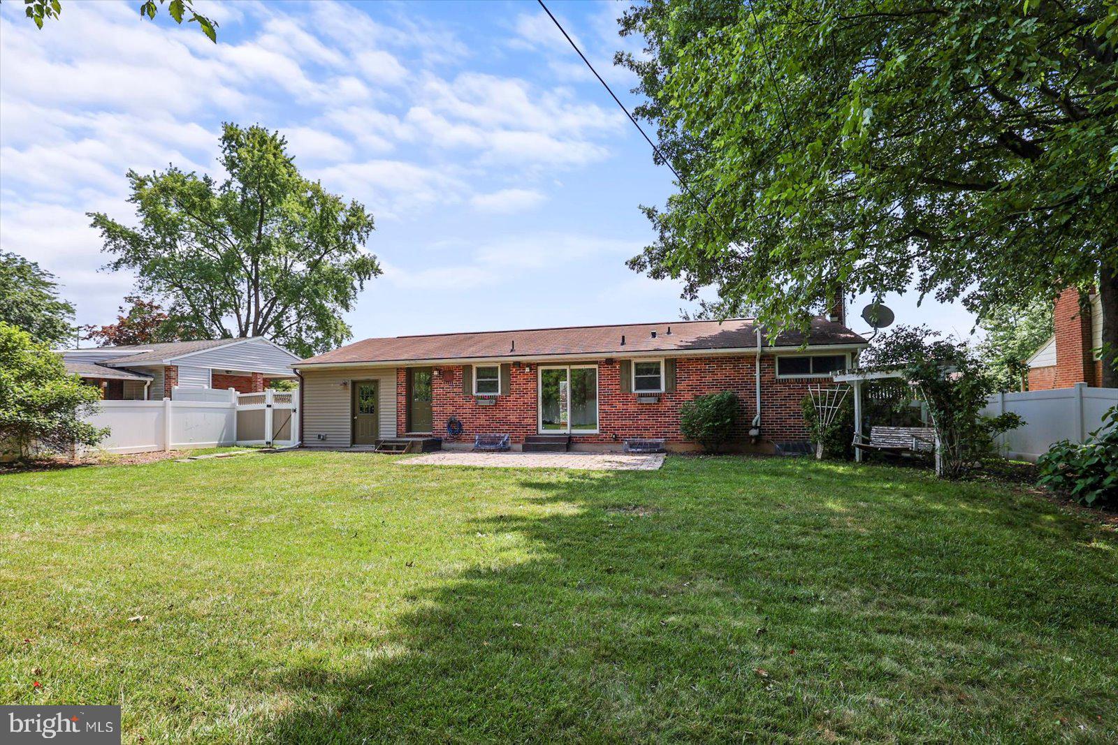 2453 Brookside Lane York, PA 17402 - Photo 7 of 40 a front view of a house with a garden