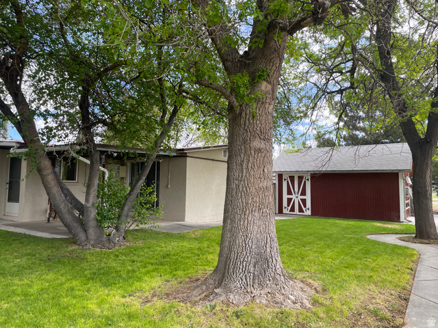 438 East Main Street Elsinore, UT 84724 - Photo 7 of 43 Red detached structure featuring white barn-style doors and a light gray roof