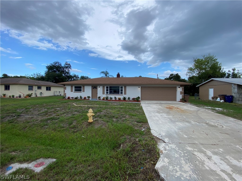 2316 Lotus Road Fort Myers, FL 33905 - Photo 2 of 35 a front view of a house with a yard