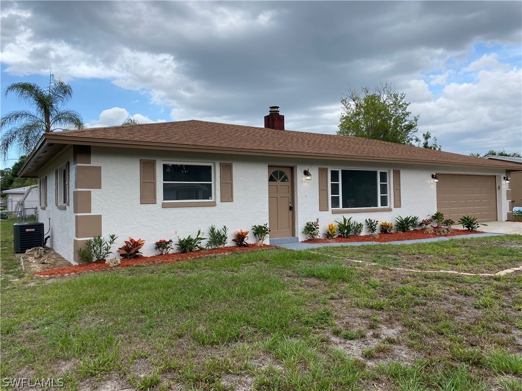 2316 Lotus Road Fort Myers, FL 33905 - Photo 3 of 35 a front view of house with yard having outdoor seating