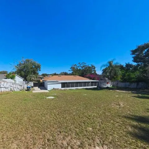 a view of a garden with swimming pool and an outdoor space