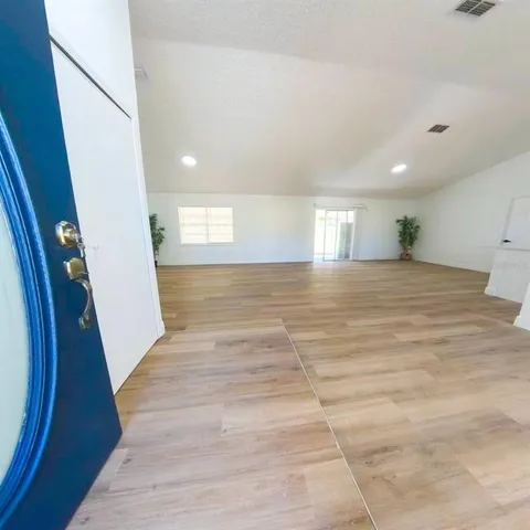 a view of an empty room and wooden floor
