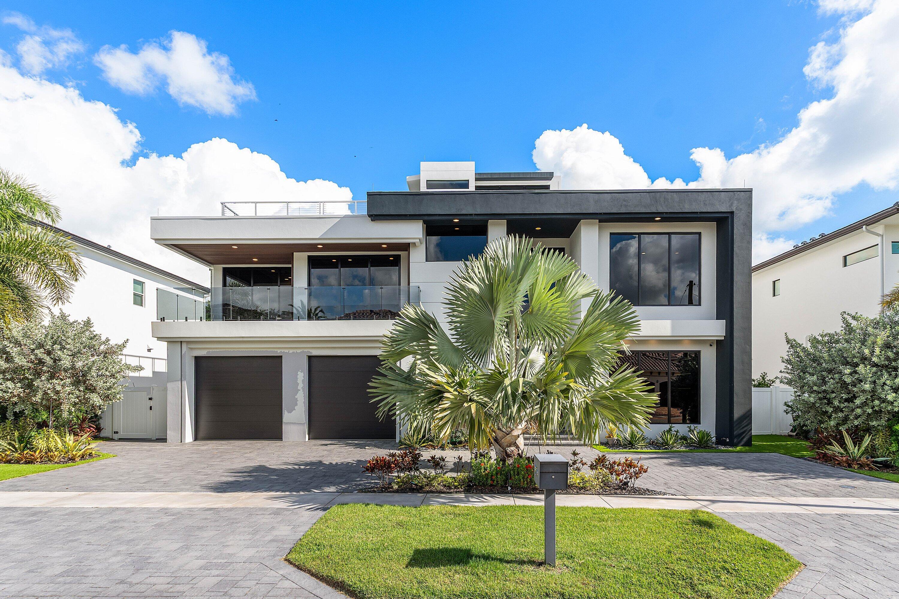 245 Northeast 6th Court Boca Raton, FL 33432 - Photo 2 of 84 a front view of a house with garden