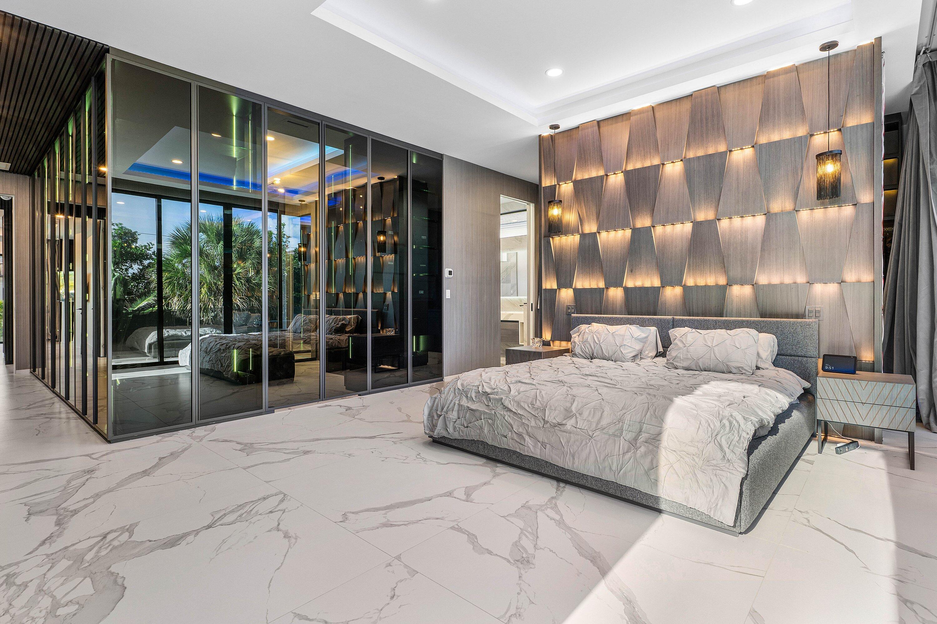 245 Northeast 6th Court Boca Raton, FL 33432 - Photo 25 of 84 a spacious bedroom with a large bed and a large window